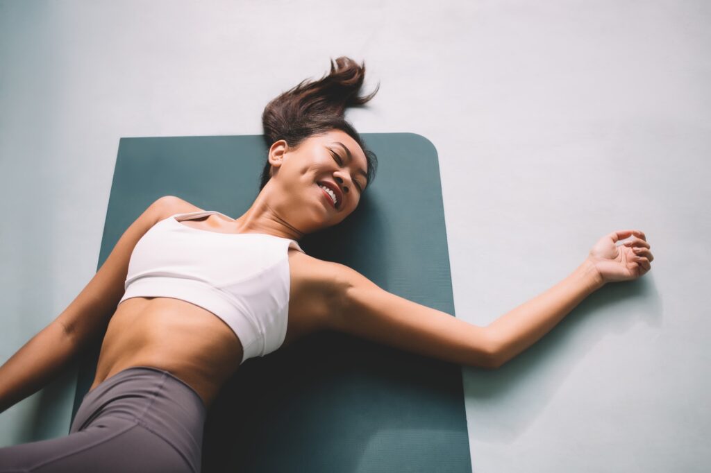 asian girl practicing yoga at spacious home